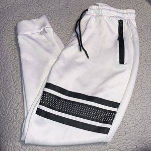 White joggers zip pockets, black stripe design